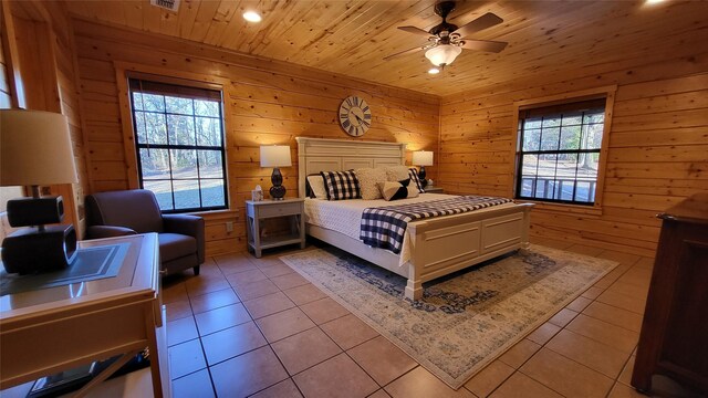 bedroom featuring wooden ceiling, multiple windows, wood walls, and light tile patterned flooring