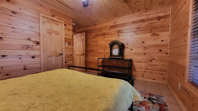 tiled bedroom featuring wood ceiling and wooden walls