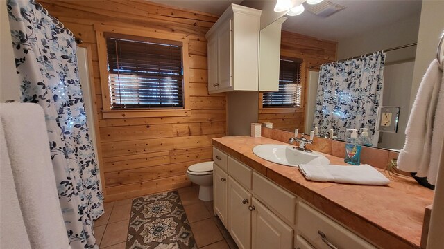 full bathroom with toilet, tile patterned floors, curtained shower, vanity, and wood walls