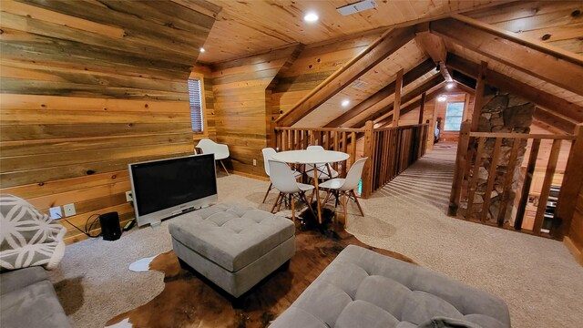 sitting room with wood ceiling, carpet, an upstairs landing, and wooden walls