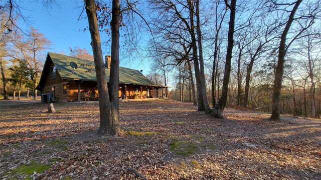 exterior space with log exterior and central air condition unit