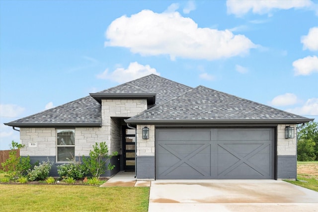 view of front of home with a front lawn and a garage