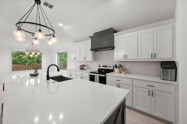 kitchen with sink, electric stove, white cabinets, and custom range hood