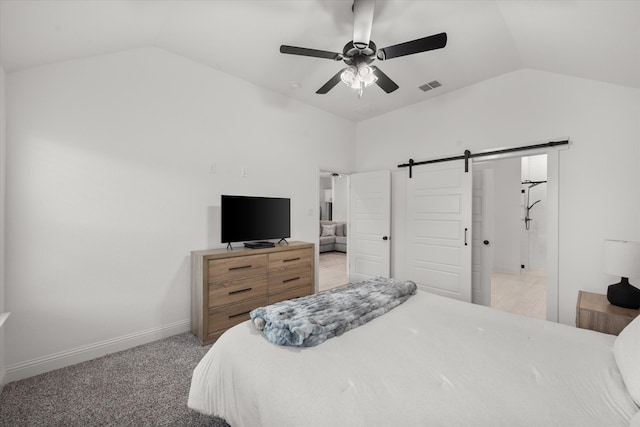 bedroom featuring light carpet, a barn door, lofted ceiling, and ceiling fan