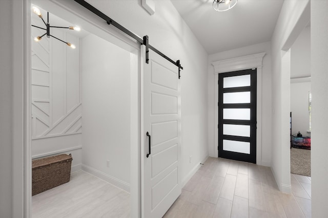 carpeted entryway featuring a barn door