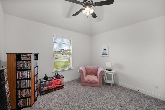 living area featuring carpet and ceiling fan