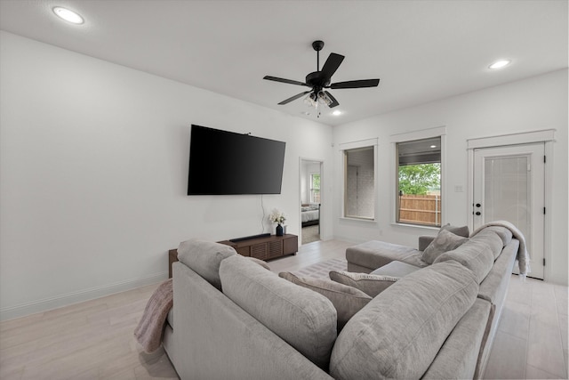 living room featuring light hardwood / wood-style floors and ceiling fan