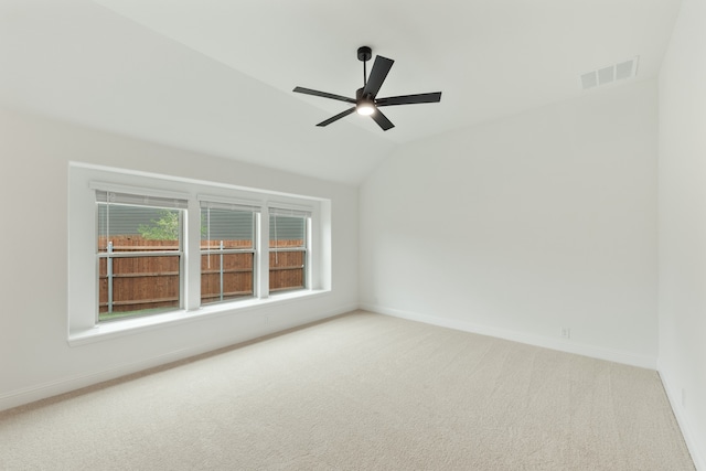 empty room featuring carpet, lofted ceiling, and ceiling fan