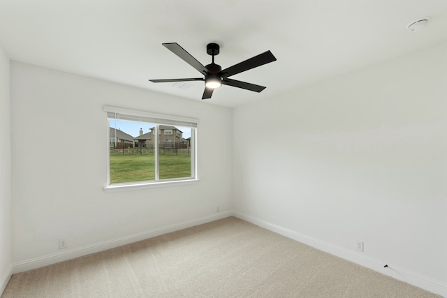 carpeted spare room with ceiling fan