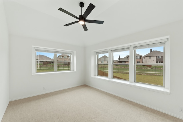 carpeted spare room with ceiling fan