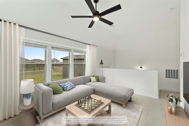 living room featuring ceiling fan, light colored carpet, and lofted ceiling