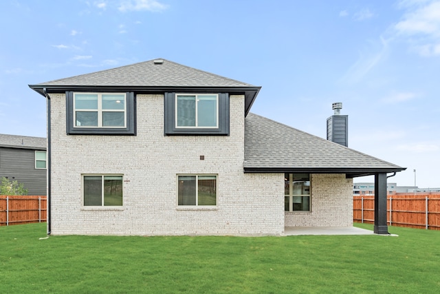 back of property featuring a yard and a patio