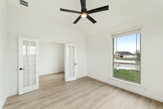 unfurnished room with light hardwood / wood-style floors, lofted ceiling, ceiling fan, and french doors