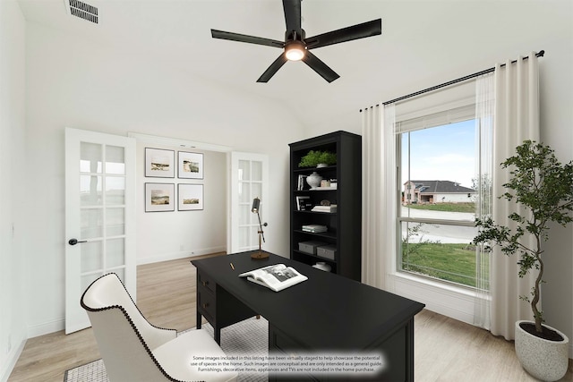 office area with light hardwood / wood-style floors, vaulted ceiling, ceiling fan, and french doors