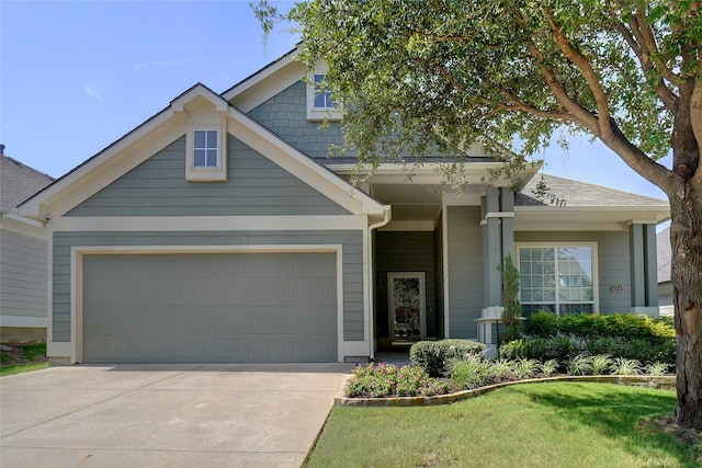 view of front of home with a garage and a front lawn