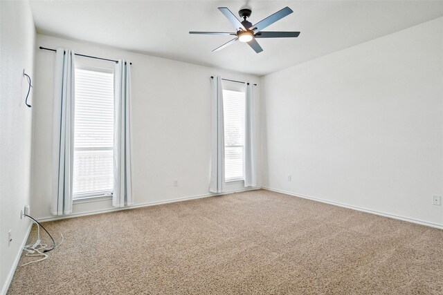 unfurnished room featuring carpet, ceiling fan, and a healthy amount of sunlight