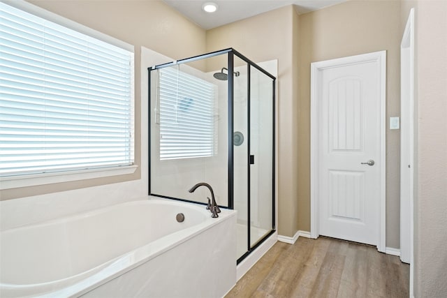 bathroom featuring separate shower and tub and hardwood / wood-style floors