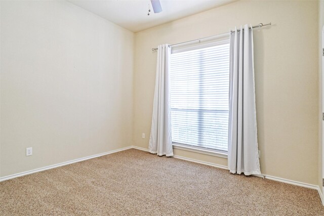 empty room featuring light carpet and ceiling fan