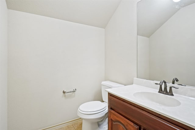 bathroom with vanity, toilet, and tile patterned floors