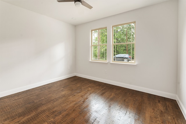 spare room featuring dark wood-type flooring and ceiling fan