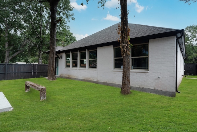 rear view of house featuring a lawn