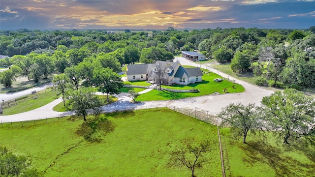 aerial view at dusk featuring a rural view