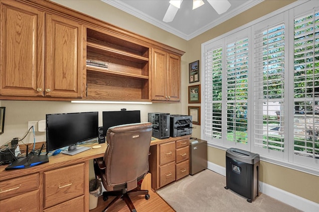 carpeted office featuring crown molding and ceiling fan