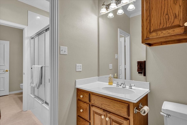 full bathroom with vanity, bath / shower combo with glass door, ornamental molding, and toilet