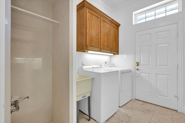 clothes washing area featuring crown molding, cabinets, washer and clothes dryer, and light tile patterned floors