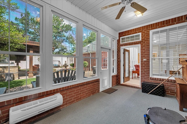 unfurnished sunroom with ceiling fan