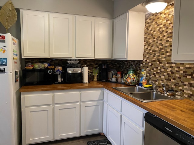 kitchen featuring white refrigerator, dishwasher, white cabinets, and butcher block countertops