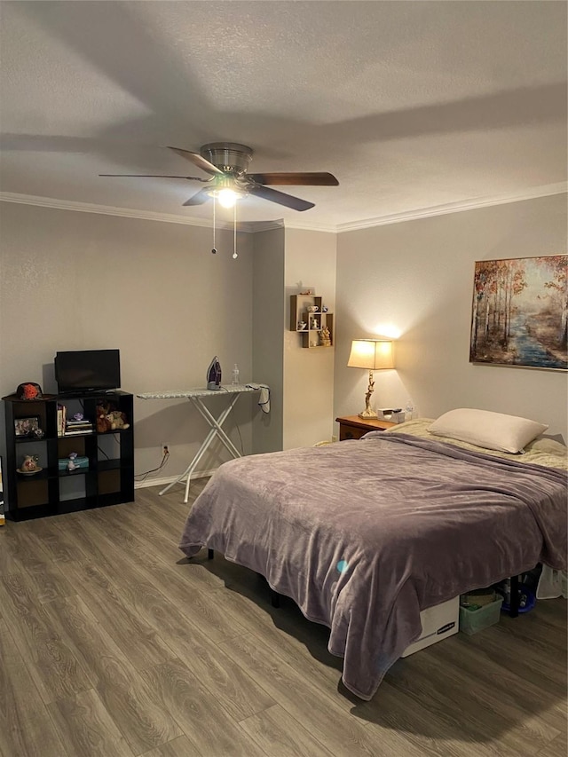 bedroom featuring ornamental molding, hardwood / wood-style floors, a textured ceiling, and ceiling fan