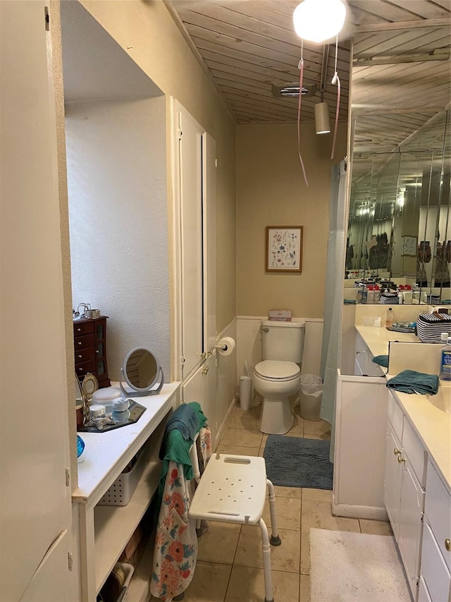 bathroom with wood ceiling, tile patterned floors, toilet, and vanity