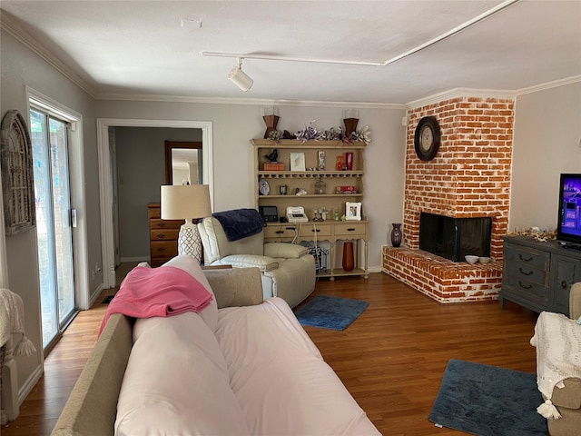 living room featuring crown molding, a brick fireplace, and hardwood / wood-style flooring