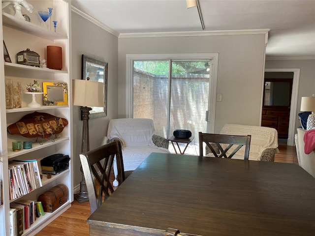 dining room with wood-type flooring and ornamental molding