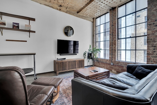 carpeted living room featuring brick wall and a wealth of natural light