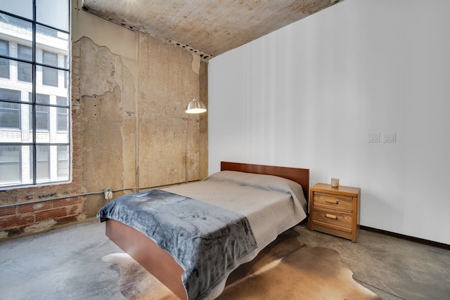 bedroom featuring concrete flooring