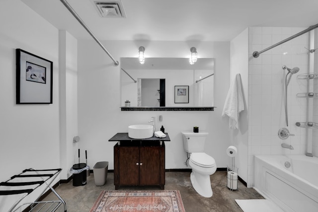 full bathroom featuring vanity, tiled shower / bath, tile patterned floors, and toilet