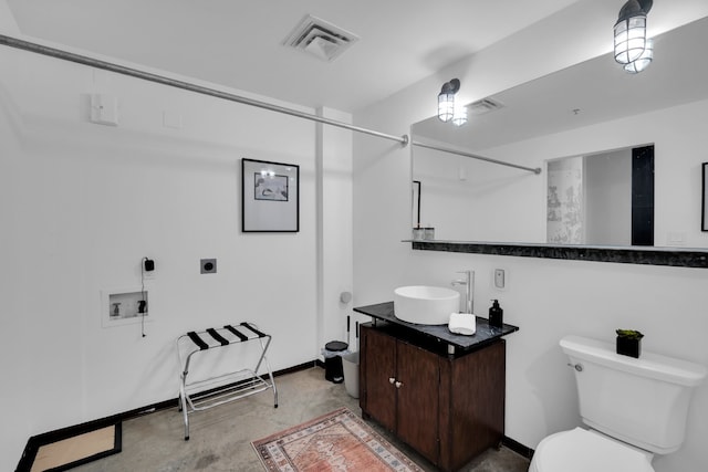 bathroom featuring vanity, toilet, and concrete floors