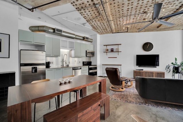 kitchen with sink, concrete flooring, ceiling fan, and stainless steel appliances