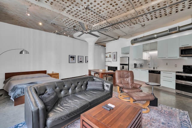 living room with concrete flooring and ceiling fan