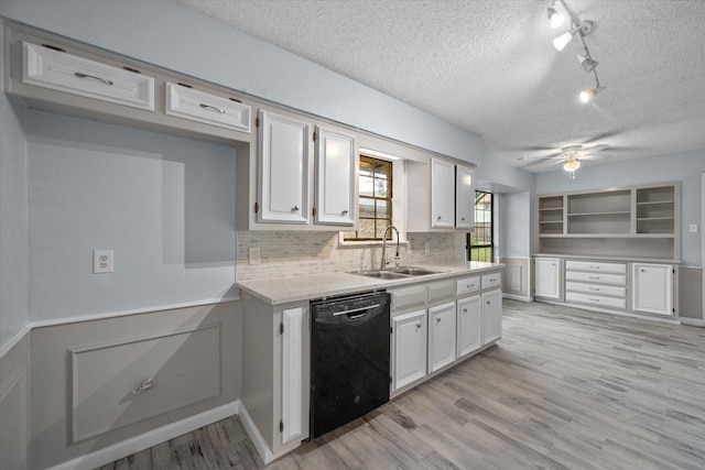 kitchen featuring white cabinetry, sink, a textured ceiling, and black dishwasher