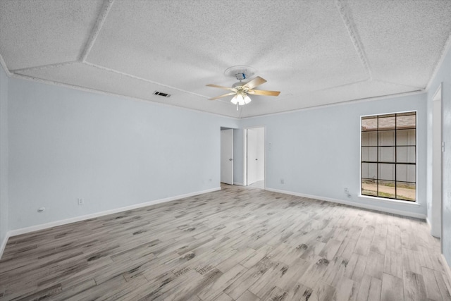 unfurnished room featuring ceiling fan, a textured ceiling, and light wood-type flooring