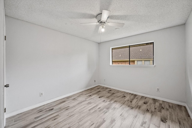 spare room featuring a textured ceiling, light hardwood / wood-style flooring, and ceiling fan