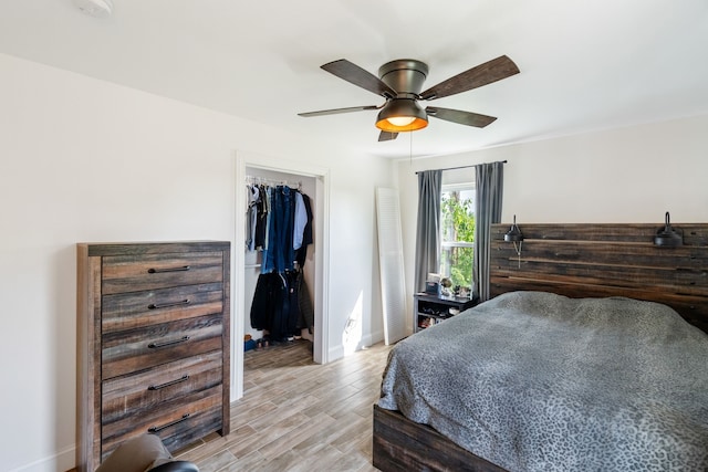 bedroom with light hardwood / wood-style flooring, a closet, and ceiling fan