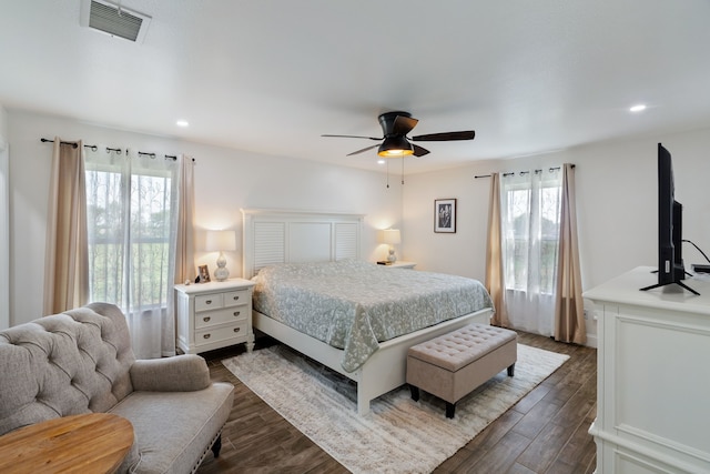 bedroom featuring multiple windows, ceiling fan, and wood-type flooring