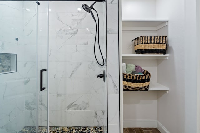 bathroom featuring an enclosed shower and hardwood / wood-style flooring