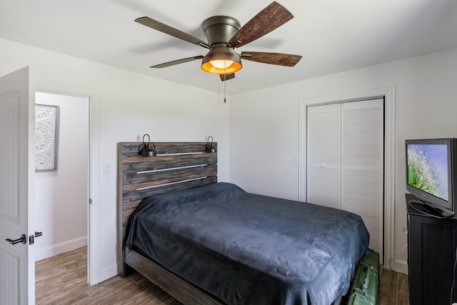 bedroom with ceiling fan, wood-type flooring, and a closet