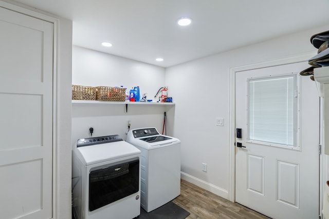 laundry room featuring light wood-type flooring and washing machine and clothes dryer