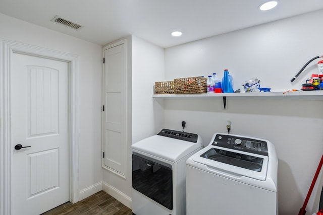 laundry room with dark wood-type flooring and washer and dryer